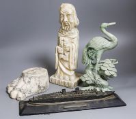 A large marble lion's paw, an alabaster monk, a soapstone crane and a white metal model of The