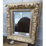 A Victorian giltwood and gesso rectangular wall mirror, with acanthus and floral mounts, W.53cm H.