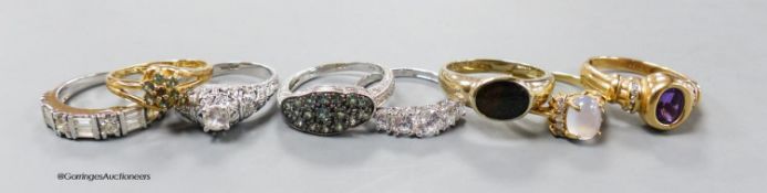 Fourteen assorted modern 14k white or yellow metal and gem set dress rings, gross 29 grams.