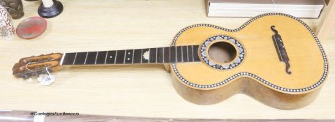 A Mexican mother of pearl inlaid acoustic guitar (no strings)