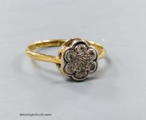 A 1920's 18ct & plat set circular diamond cluster ring, size M/N, gross 1.9 grams.