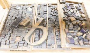 Three trays of printing blocks and letters two other patterned printing blocks and a large brass