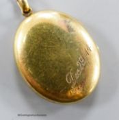 A George V 15ct oval locket, with engraved date, 24mm, gross 4 grams.