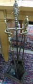 A pair of three Louis XV style brass fire implements and matching stand