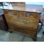 An 18th century crossbanded walnut chest of two short and three graduated long drawers, on bracket