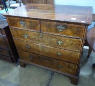 An 18th century crossbanded walnut chest of two short and three graduated long drawers, on bracket