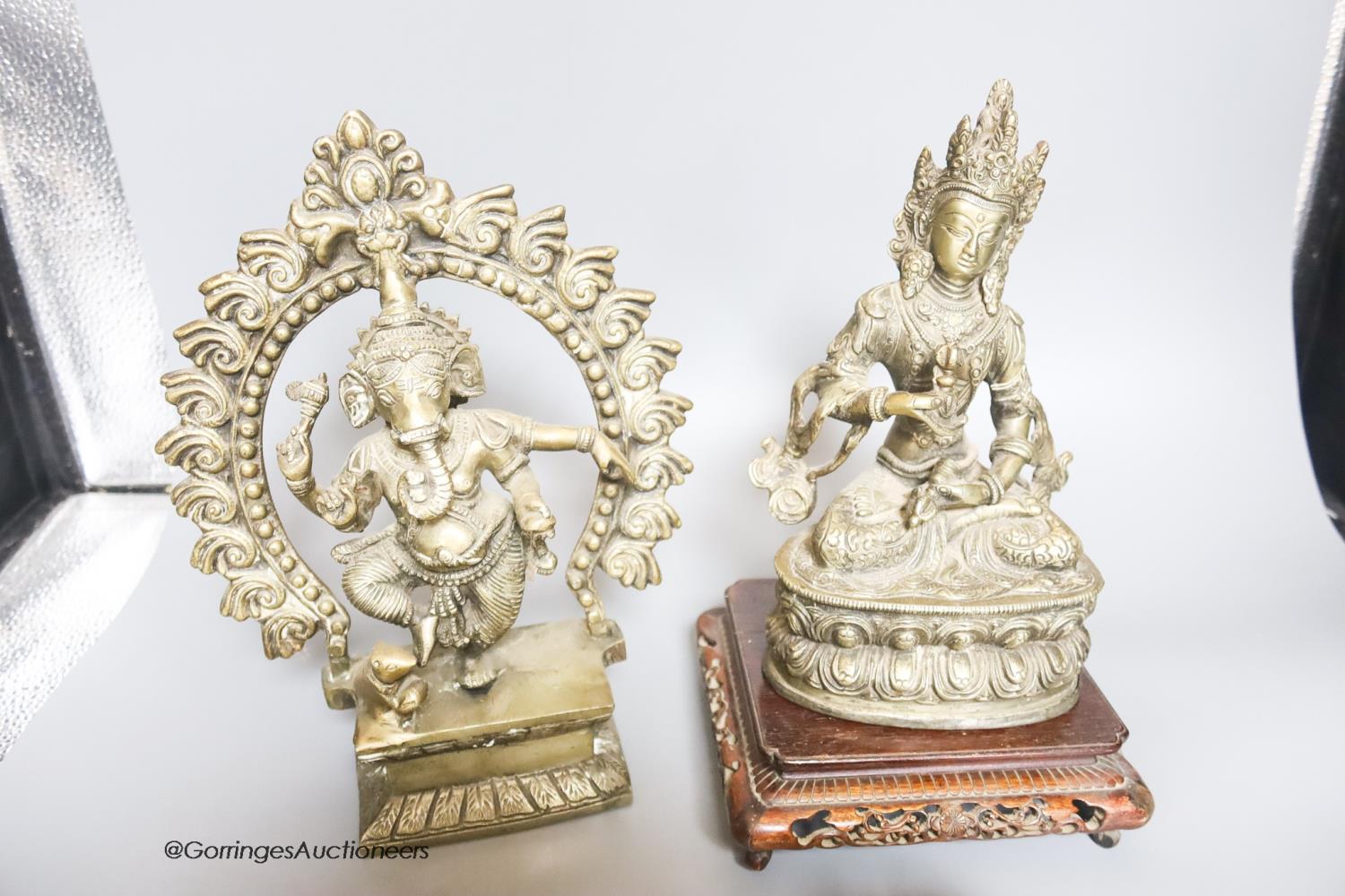 Two reproduction brass figures of Indian deities, a bell, a carved stand and a plaster plaque, - Image 4 of 4