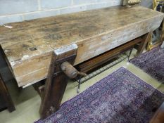 A 19th century pine workbench with original vice, W.244cm D.70cm H.83cm