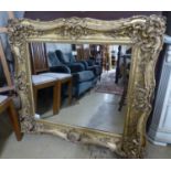 A Victorian giltwood and gesso rectangular wall mirror, (formerley a picture frame), W.110cm H.