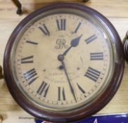 An early 20th century mahogany circular wall clock, with key and pendulum, diameter 39cmWith single