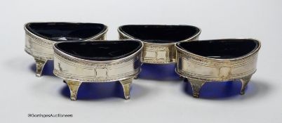 A set of four George III silver oval boat shaped salts, with blue glass liners, Robert Jones II,