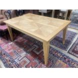 A contemporary inlaid oak extending dining table, 236cm extended, two spare leaves, W.106cm H.75cm