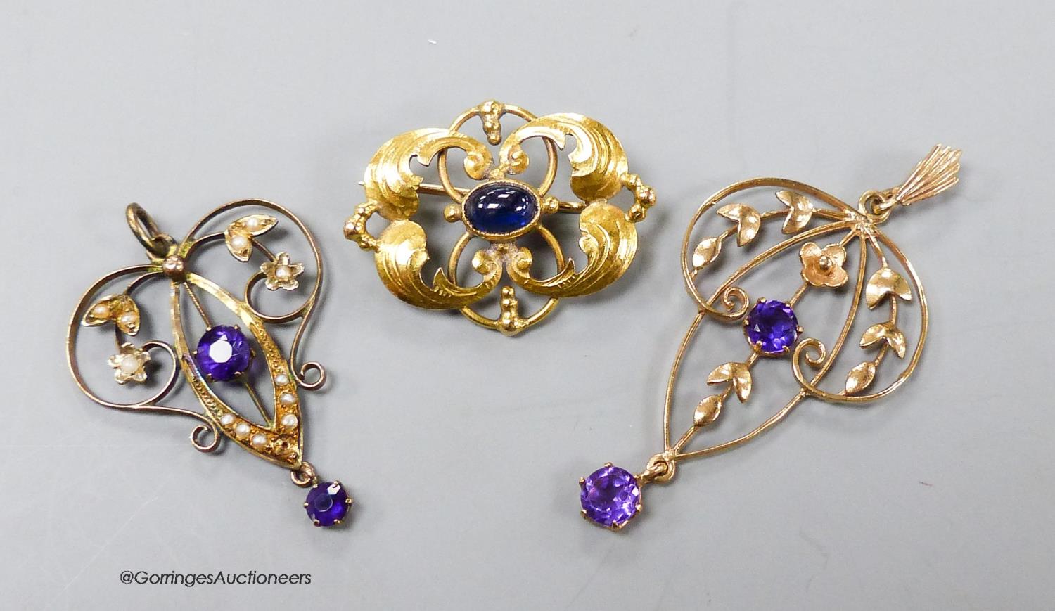 Two early 20th century yellow metal and amethyst set drop pendants, one stamped 9ct with seed
