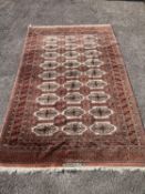 A pale red ground Tekke rug with signed border, 260 x 162cm