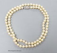 A single strand cultured pearl necklace, with 18ct white metal and diamond set bow clasp, 72cm,