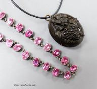 A Victorian jet mourning locket, 35mm, on later necklet and a white metal and pink paste necklace,