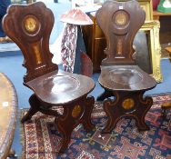 A pair of 19th century Italian style walnut hall chairs with painted armorials, width 46cm, height