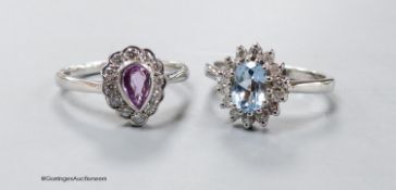 A modern 9ct white gold, pink sapphire and diamond cluster ring, size O and a similar blue topaz