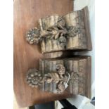 A pair of Indian teak wall brackets carved with lotus. W-25, H-34cm.