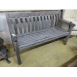 A weathered teak garden bench. W 150 cms.