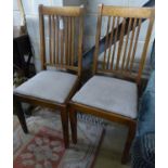 A set of four Edwardian oak dining chairs