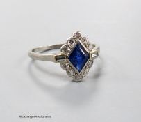 A 1920's white metal (stamped platinum), sapphire, baguette and round cut diamond cluster set