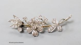 A mid 20th century white metal and diamond set floral spray brooch, 52mm, gross weight 8.3 grams.