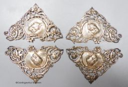 A set of four late Victorian pieced silver triangular mounts, decorated with Reynold's Angels,