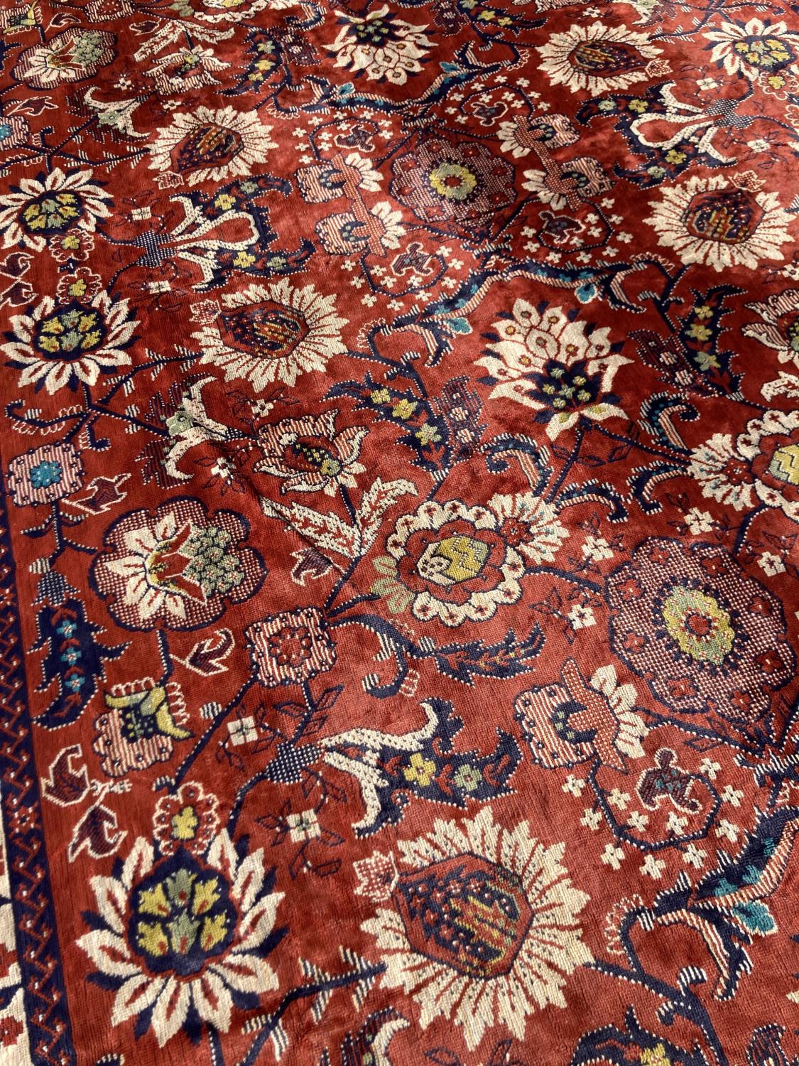 A large embroidered silk rug with a claret red ground interspersed with symmetrical foliate - Image 3 of 5