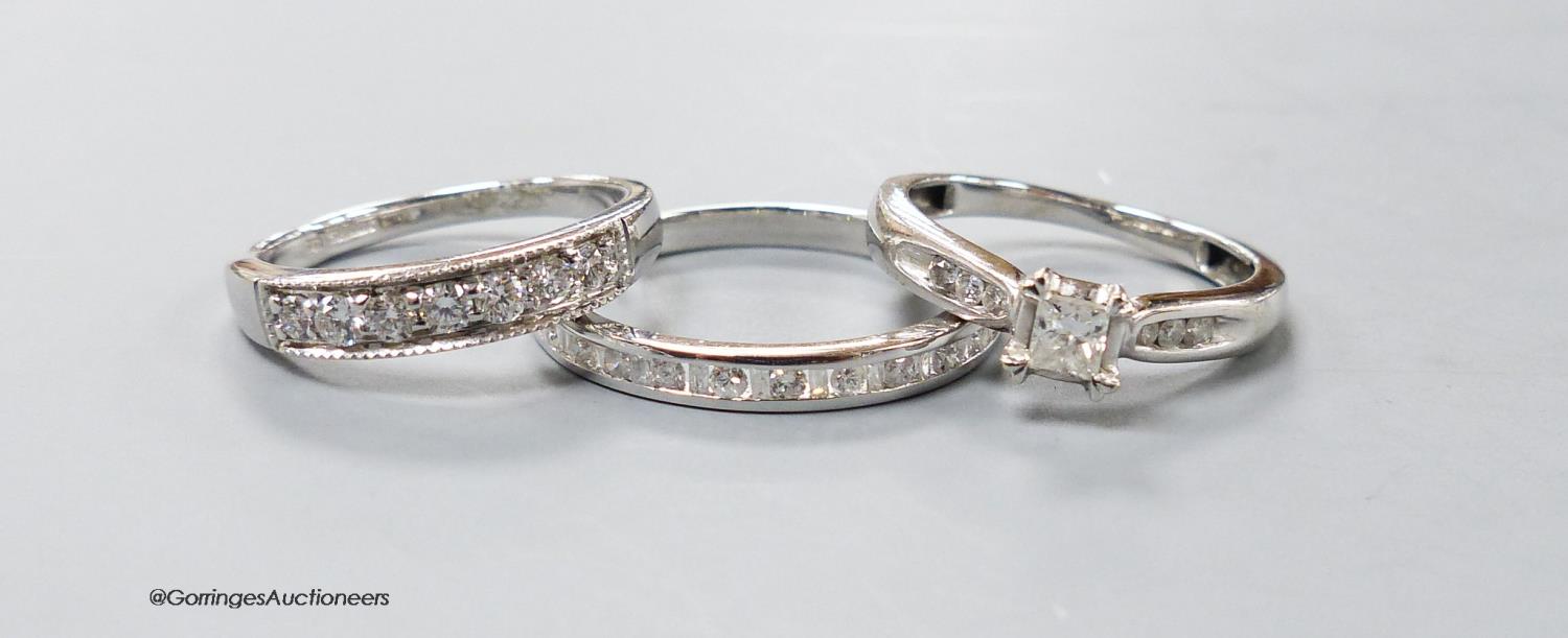 Two modern 9ct white gold and diamond set rings including a seven stone half hoop and a white metal
