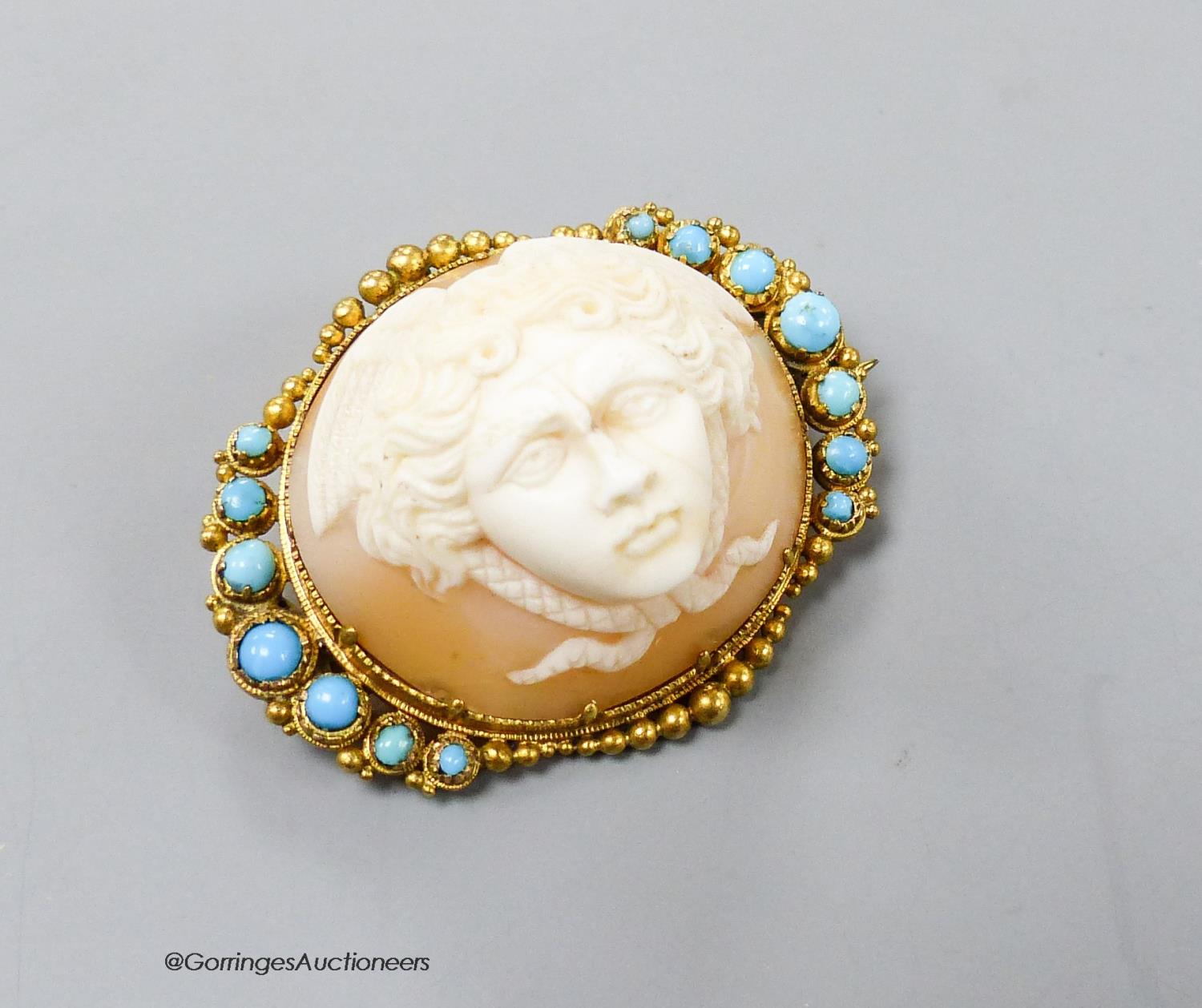 A Victorian yellow metal mounted cameo shell and turquoise set oval brooch, carved with the head of