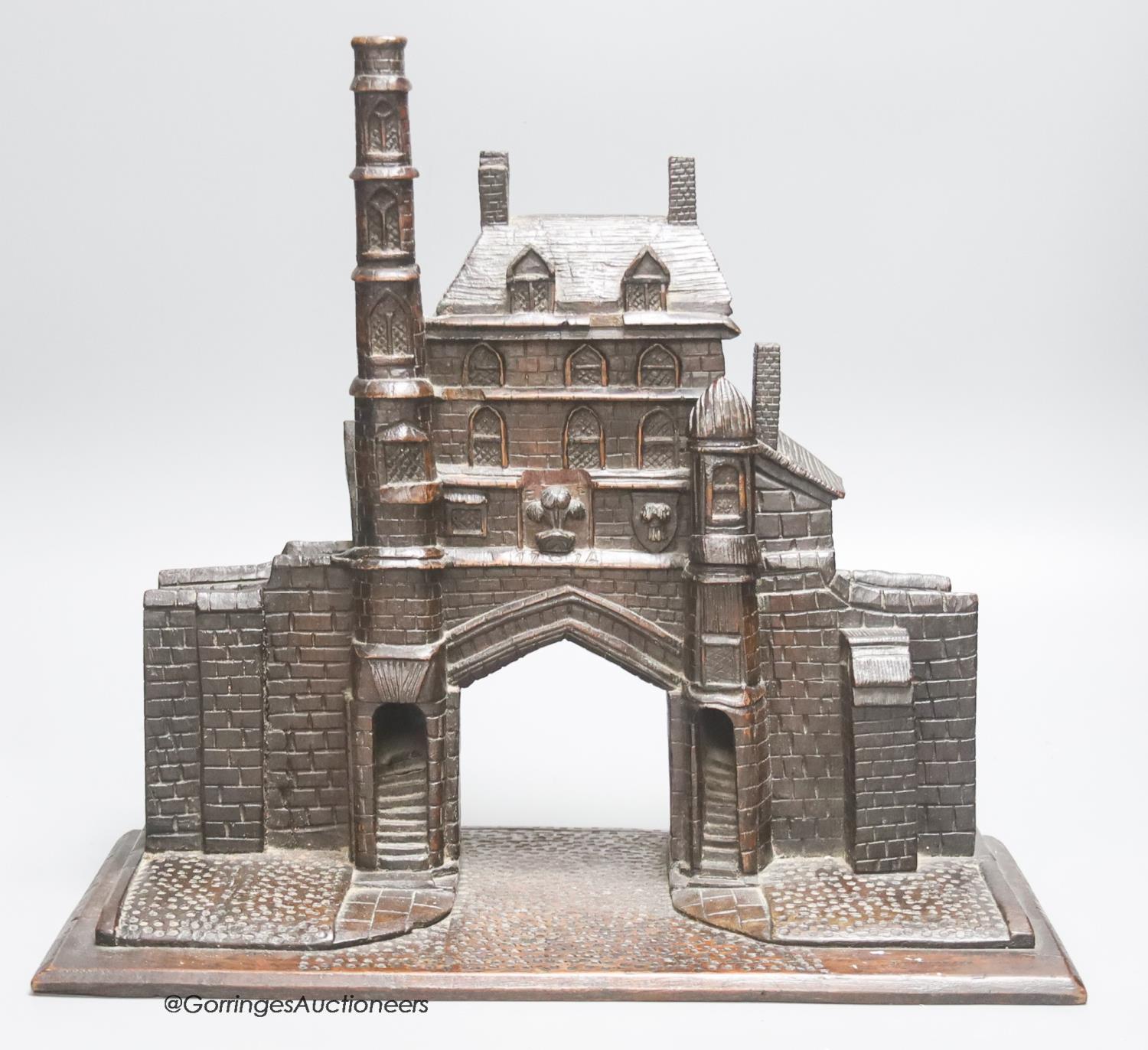 A 19th century carved oak model of a medieval Gatehouse, stamped A. Cotgreave, and inscribed 1774,