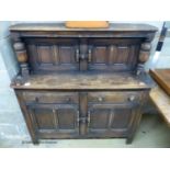 An Ercol oak court cupboard, length 122cm, depth 45cm, height 124cm