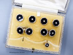 A cased 18ct, plat, black onyx and seed pearl set octagonal seven piece (ex eight) dress stud set,