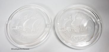 Two Lalique glass 'Santa Maria' ashtrays, moulded with clippers, signed, diameter 17cm