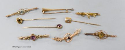 Four assorted early 20th century 9ct and gem set bar brooches, gross 9.1 grams, two yellow metal