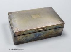 A George V silver mounted rectangular cigarette box, 13.7cm, a silver matchbox sleeve and a
