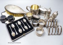 Small silver including a pair of silver toastracks, silver mug, pair of peppers, trophy cup,