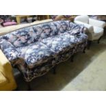 A late 19th century Continental mahogany scroll arm sofa and armchair, sofa upholstered in a floral