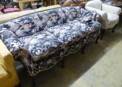 A late 19th century Continental mahogany scroll arm sofa and armchair, sofa upholstered in a floral