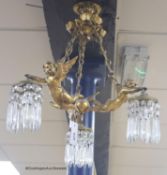 A Louis XV style gilt metal three light ceiling chandelier, mounted with winged amorini, drop 48cm