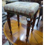 A small Regency mahogany upholstered stool, on fluted legs, W.35cm D.29cm H.51cm