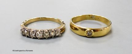 A yellow metal and graduated seven stone diamond set half hoop ring, size O and one other solitaire