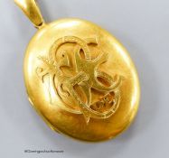 A Victorian yellow metal oval pendant locket with applied monogram, overall 63mm, gross weight 31.9