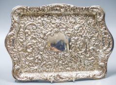 An Edwardian embossed silver rectangular dressing tray, Henry Matthews, Birmingham, 1906, 26,5cm,