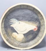 A papier mache dish with a painted interior of a chicken and eggs, diameter 52cm