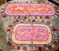 Four 20th century silk embroidered oval table centres edged with multi-coloured tassels, length