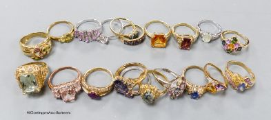 Twenty assorted modern 9ct or 9k and gem set dress rings, gross 65.5 grams.