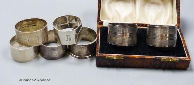 A cased pair of George V silver napkin rings, one other pair of silver napkin rings and three other