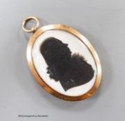 A yellow metal mounted oval double silhouette by John Miers, lady to one side and a larger